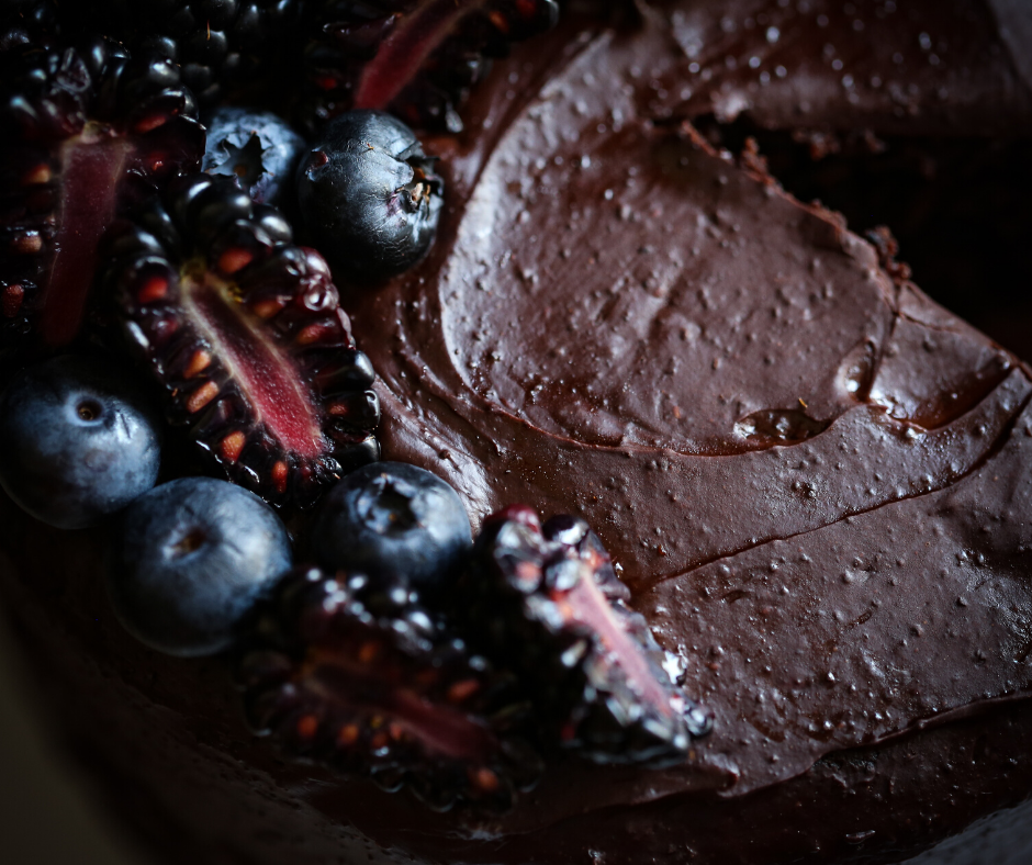 top view of chocolate frosting and berries on top of cake