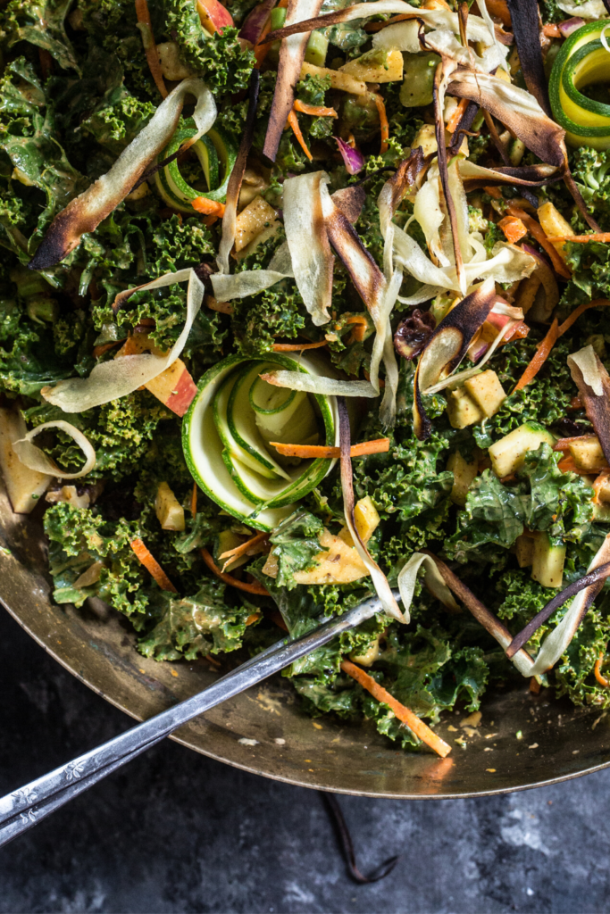 kale salad in bowl with chopsticks