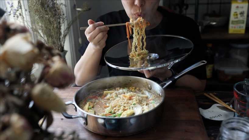 Joanne eating Creamy Vegan Ramen Noodles with chopsticks.