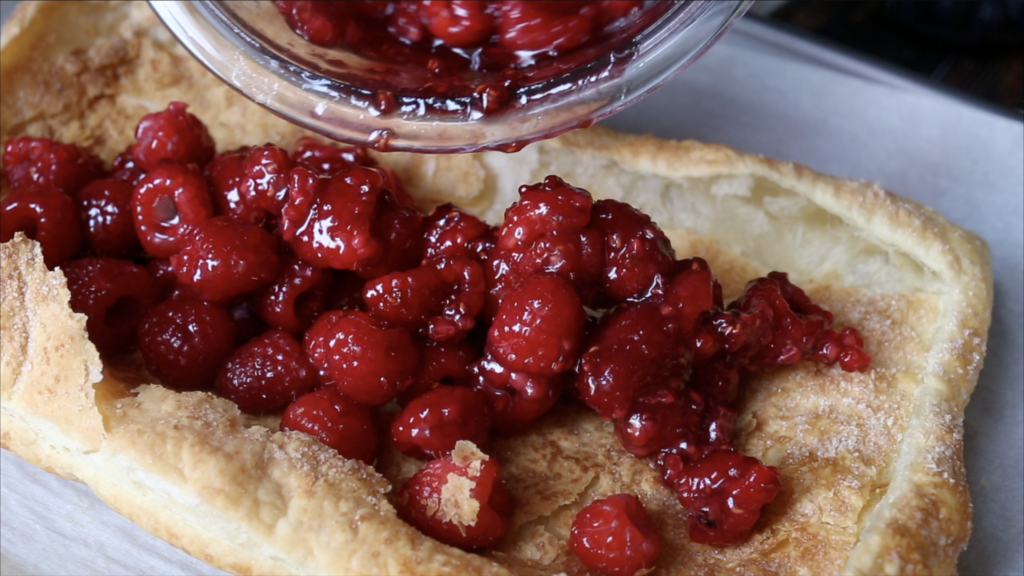 adding raspberries to puff pastry