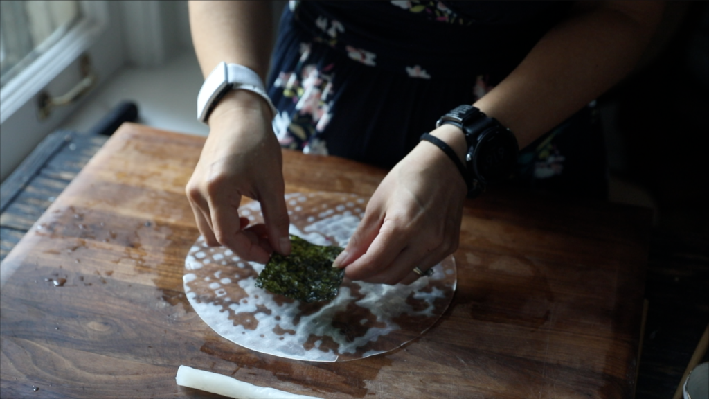 adding fried seaweed to the rice paper