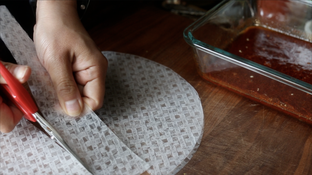 Cutting the rice paper into strips.