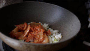 Add kimchi to pan