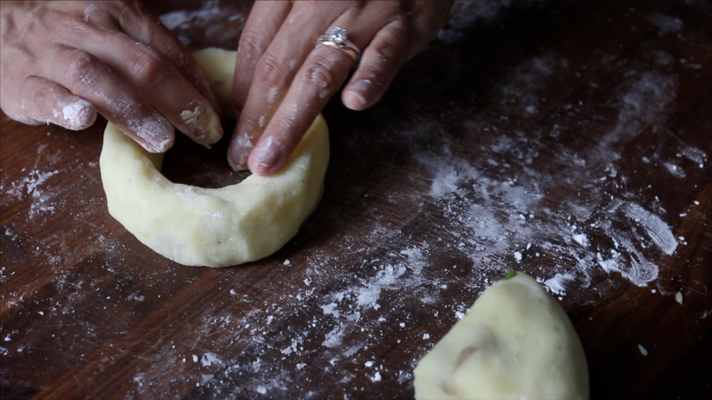 molding the potato dough around the onion ring