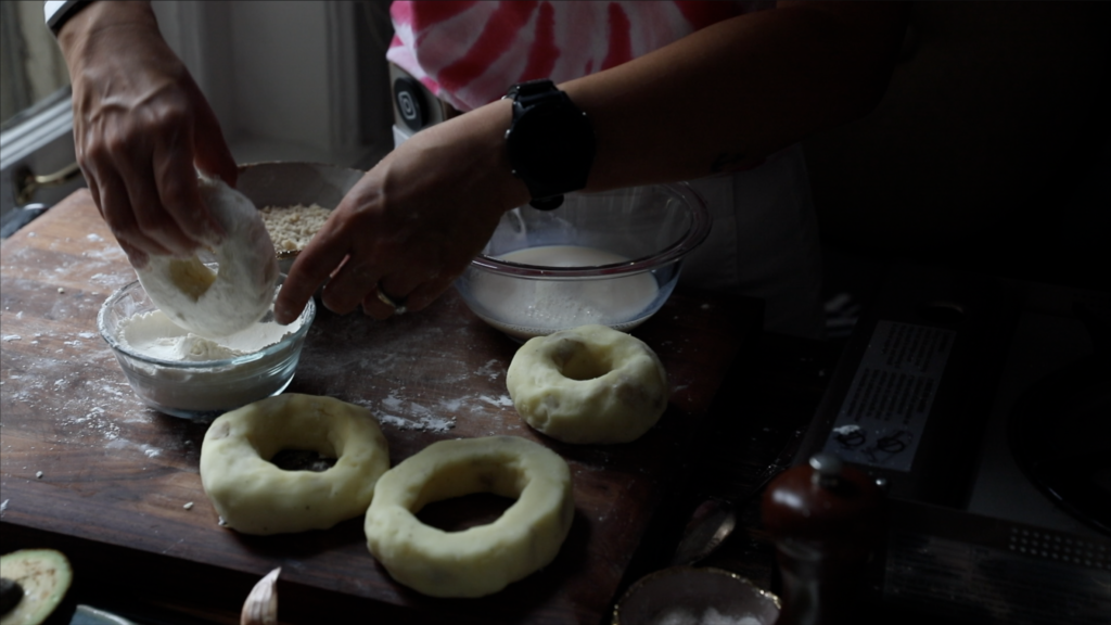 dipping the donut in the flour