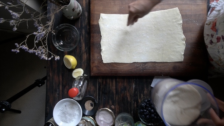 Showing how to add sugar to the puff pastry dough of The Vegan Berry Galette