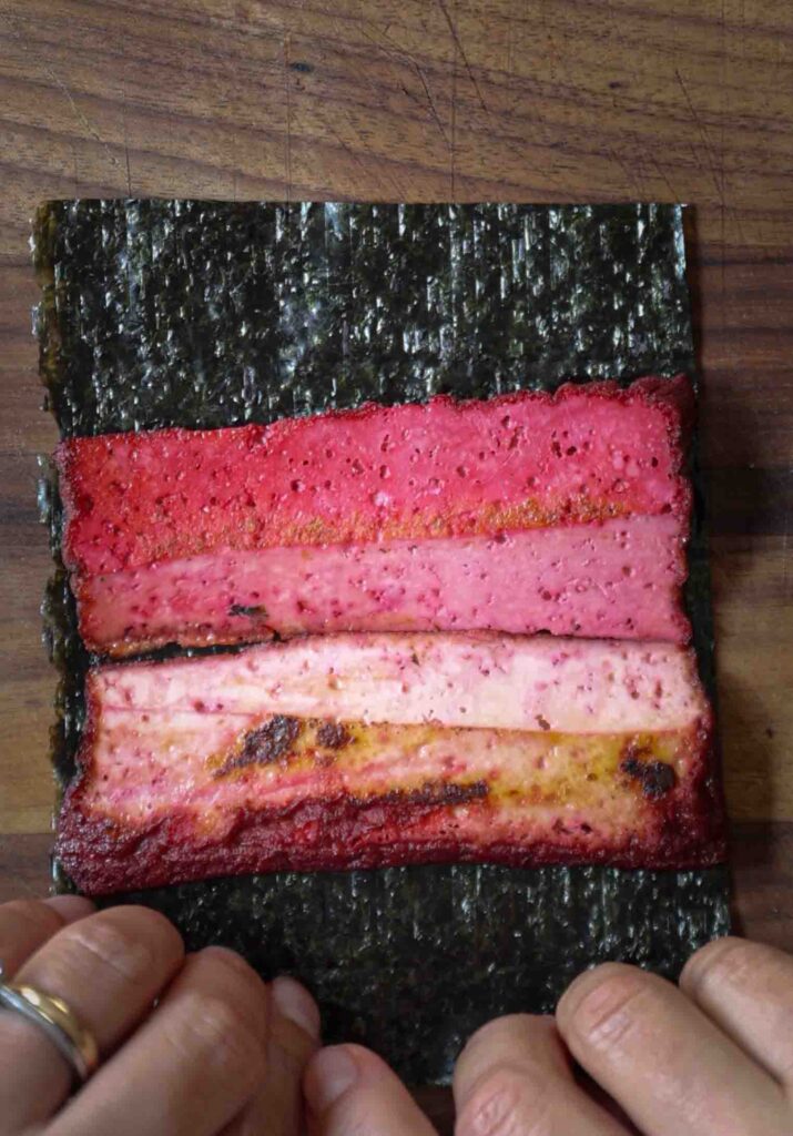 Pink-tofu-half-logs-on-seaweed-sheet