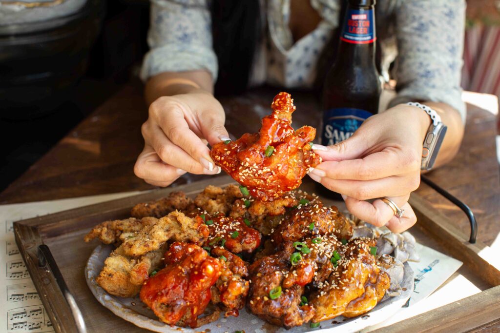 holding-vegan-fried-chicken-with-spicy-sauce