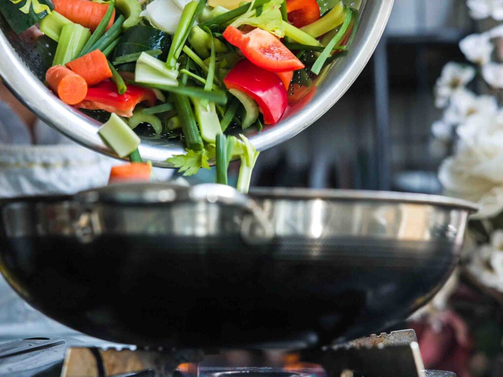 adding-veggies-to-pan-for-vegan-dumpings-recipe
