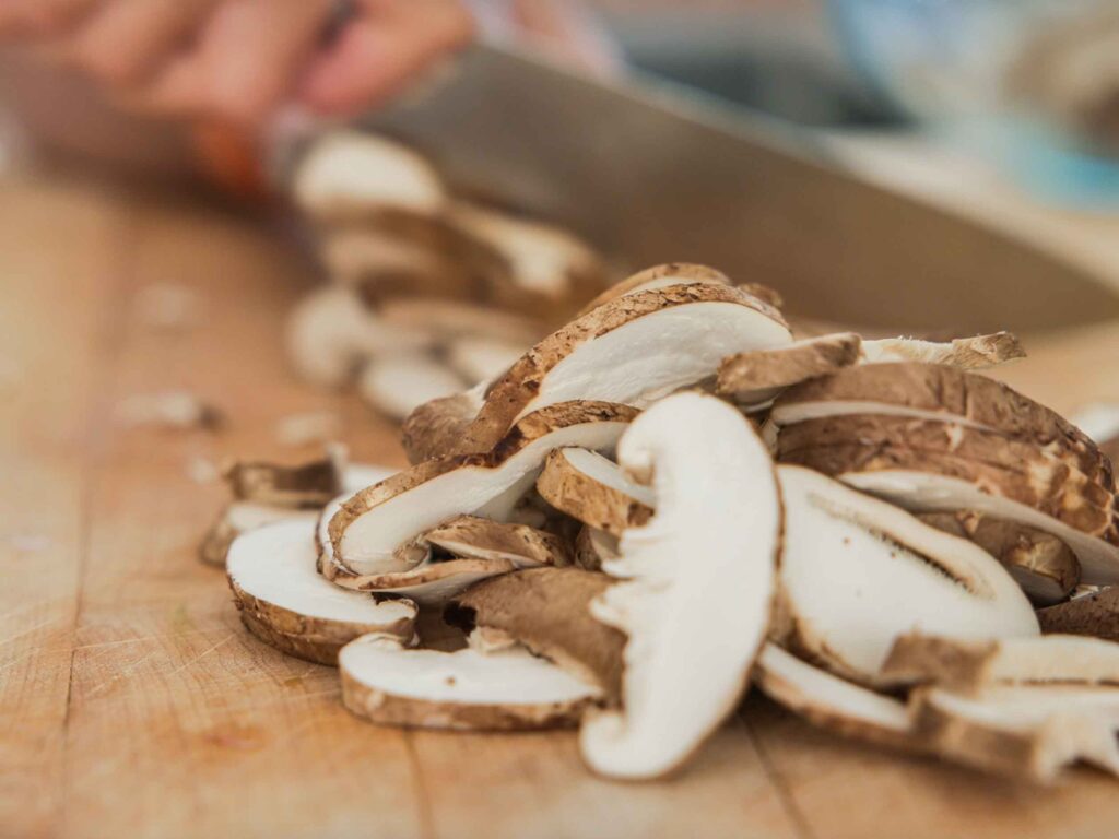 chopping-shiitake-mushrooms-for-vegan-dumplings-recipe
