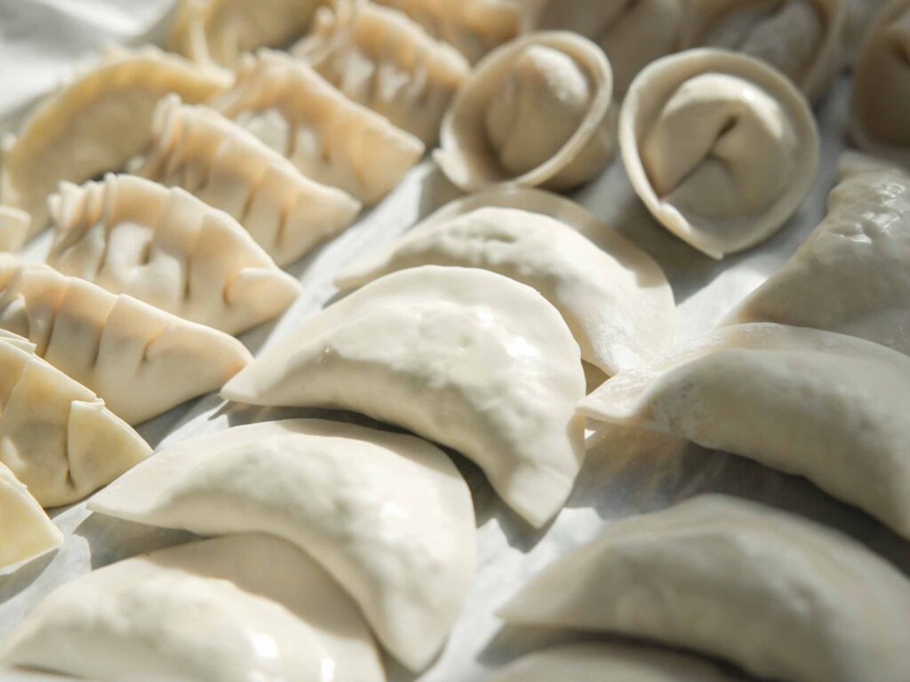 folded-dumplings-on-a-parchment-lined-tra