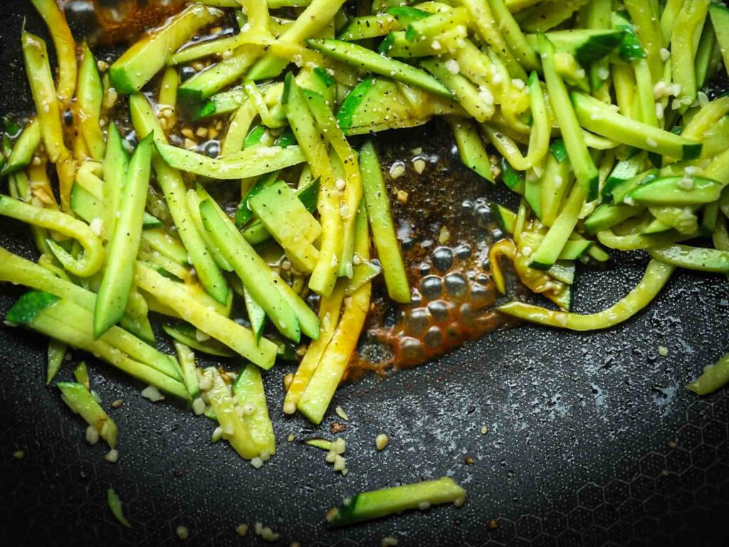 julienned-zucchini-for-korean-zucchini-banchan-cooking-in-pan