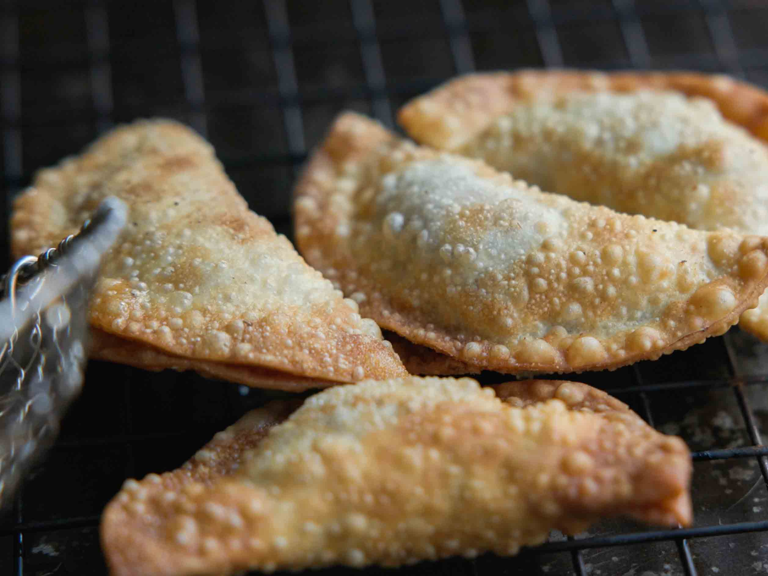 placing-deep-fried-dumplings-on-wire-rack