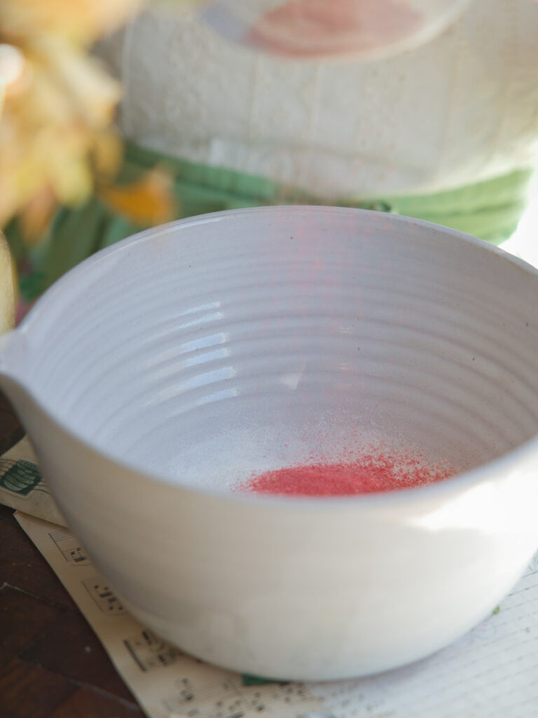 adding-ground-freeze-dried-strawberries-to-bowl-for-pink-mochi