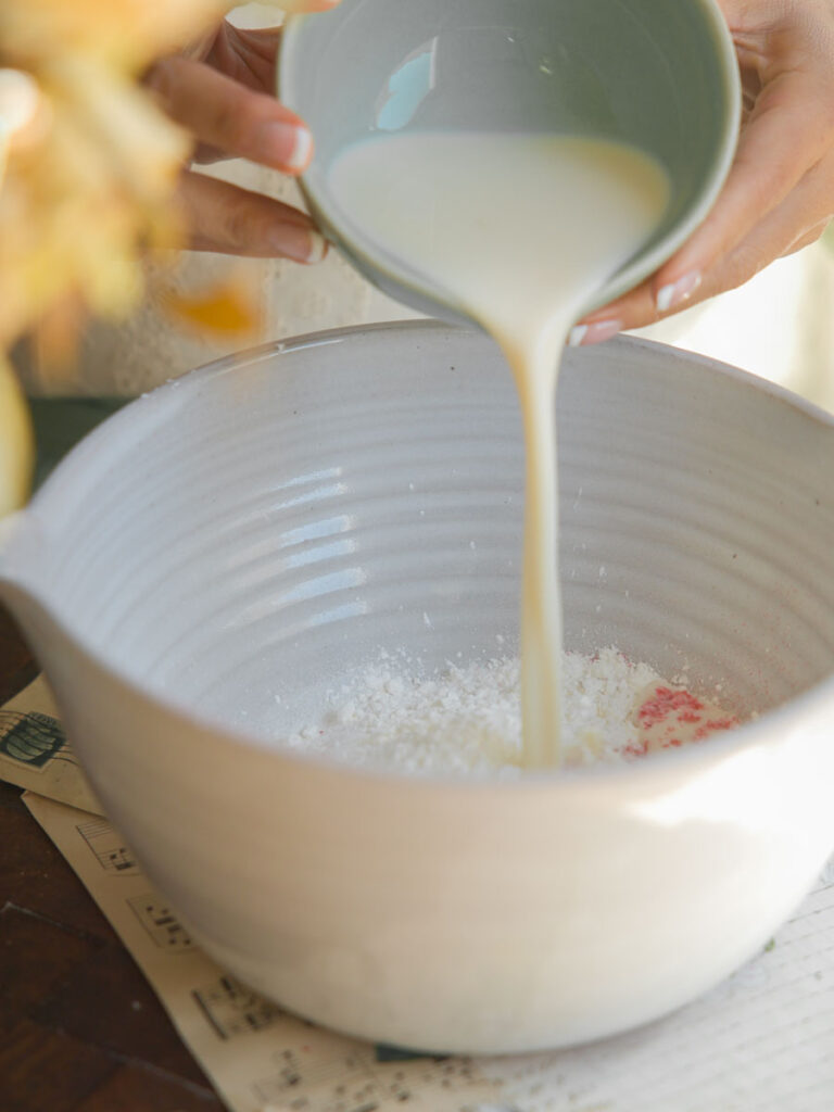 pouring milk into pink mochi batter