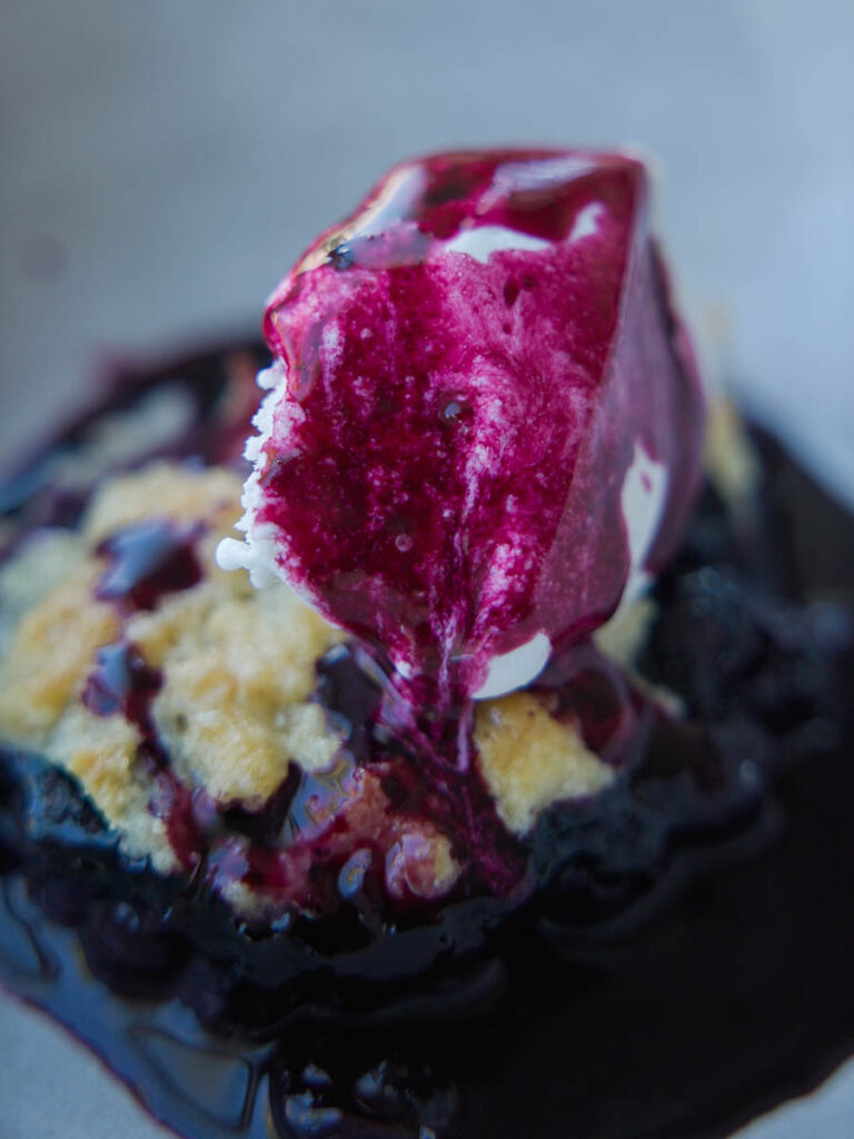 blueberry-syrup-on-top-of-ice-cream-on-vegan-blueberry-cobbler