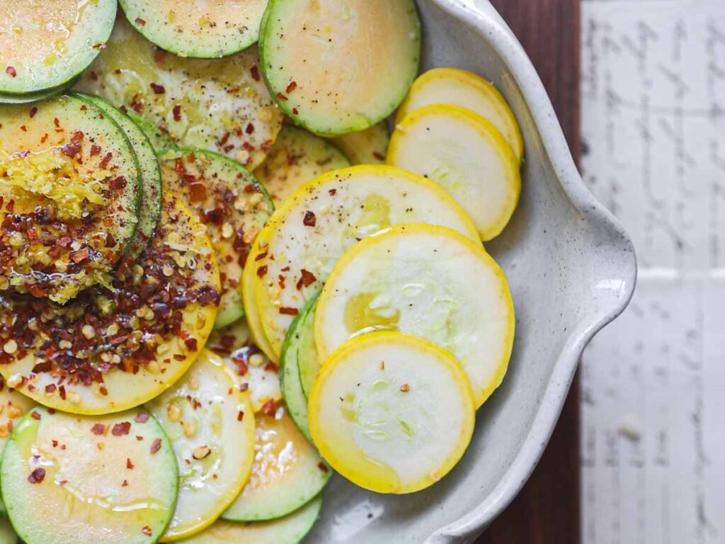 close-up-of-squash-rounds-with-chili-flakes-and-lemon-zest-and-olive-oil.