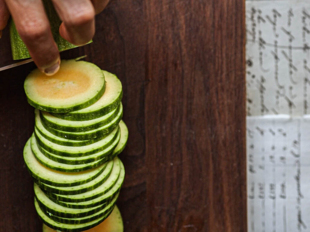 close-up-shot-of-slicing-zucchini-into-rounds