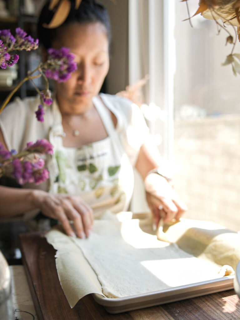 placing-pastry-dough-on-baking-sheet-lined-with-parchment-paper