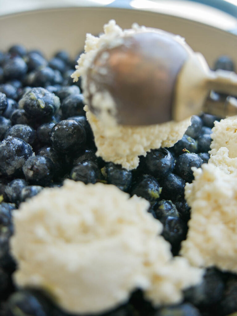 scooping-biscuit-batter-over-blueberries