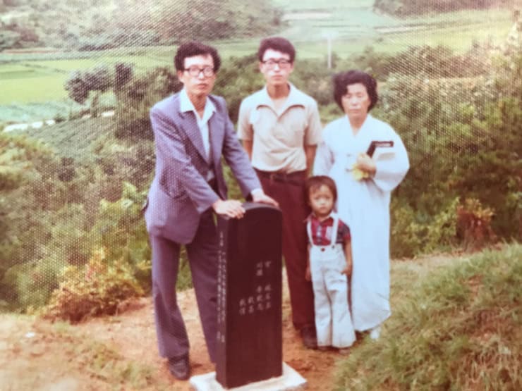 Joanne's grandmother, father, and uncles at my grandfather's grave.