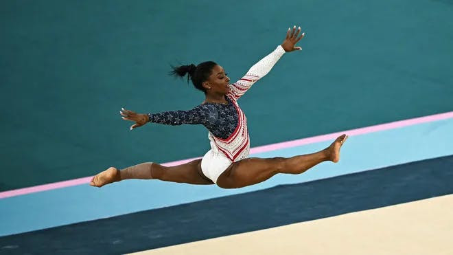 Simone Biles flying through the air