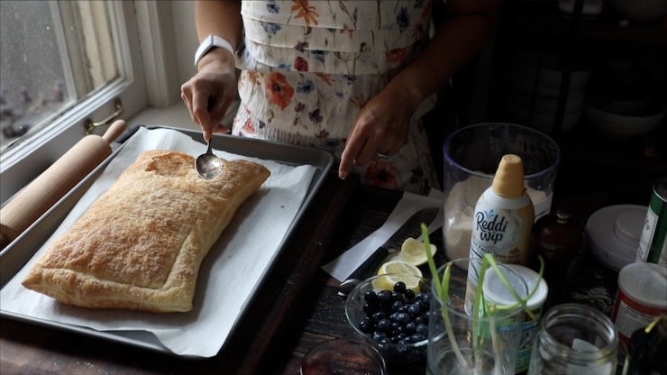 Tapping down the center of the puff pastry.