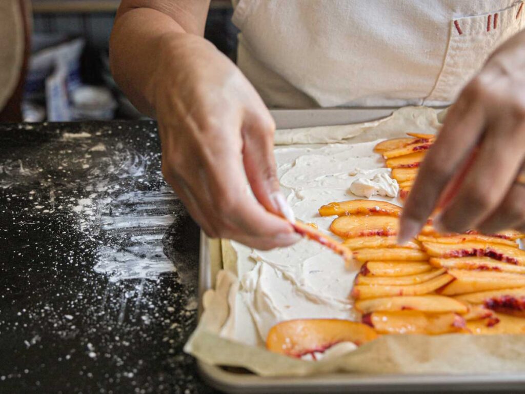 arranging-peach-slices-onto-peach-galette