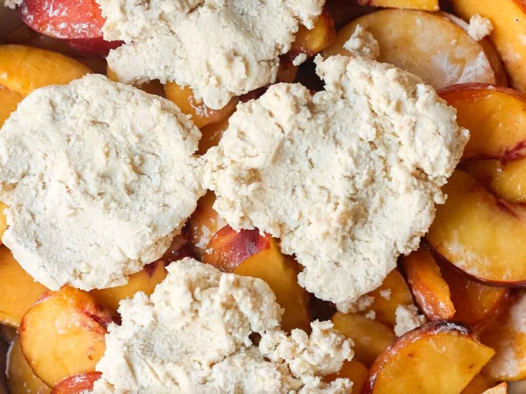 biscuit-topping-dough-on-top-of-peaches