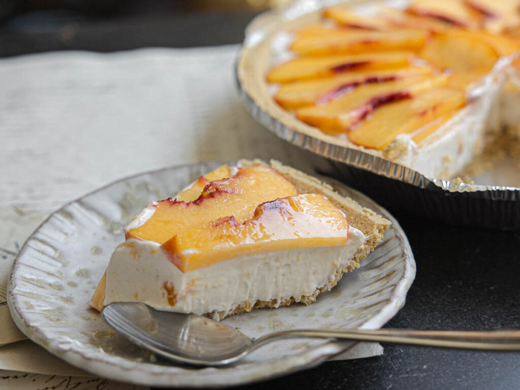 close-up-of-JUST-slice-of-vegan-peaches-cream-cheesecake-with-spoon