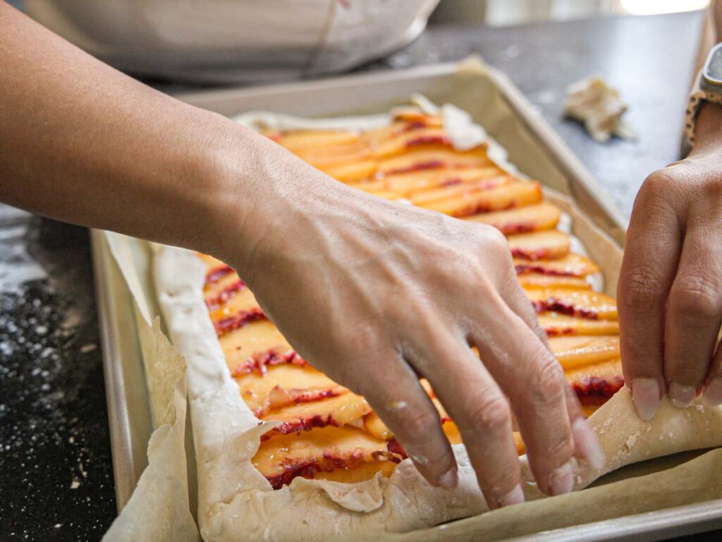 folding-galette-pastry-over-peaches