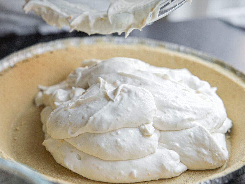 pouring-cream-cheese-filling-into-crust