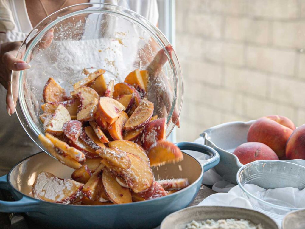 pouring-peaches-into-baking-pan