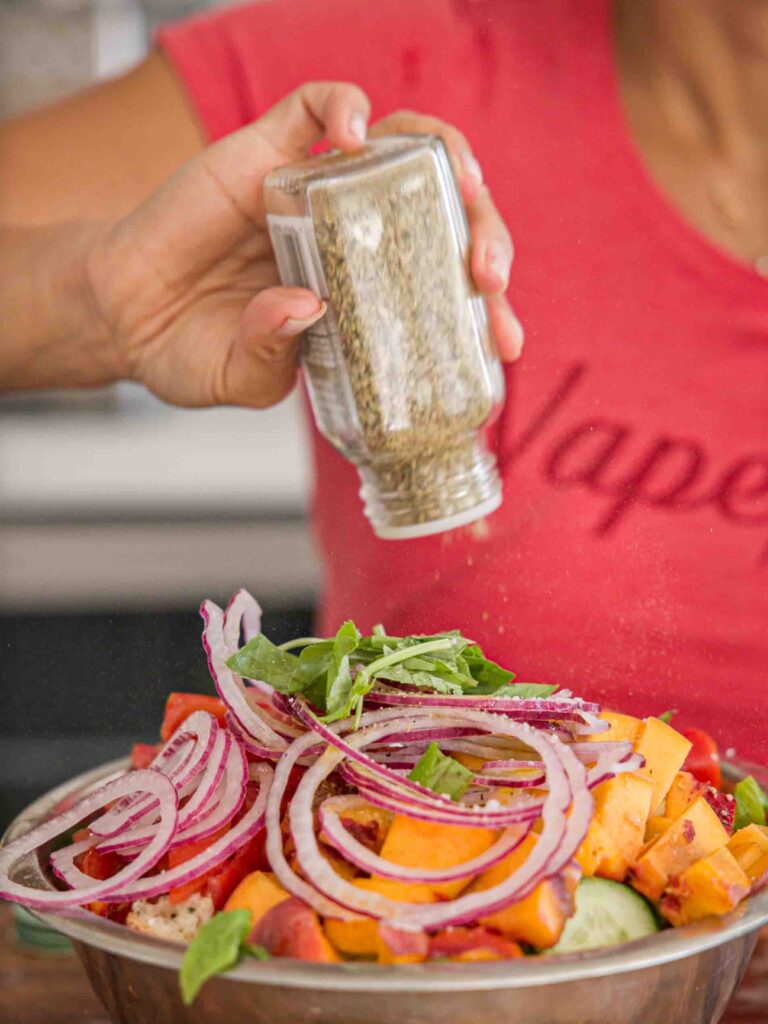 adding-italian-seasoning-to-bread-salad