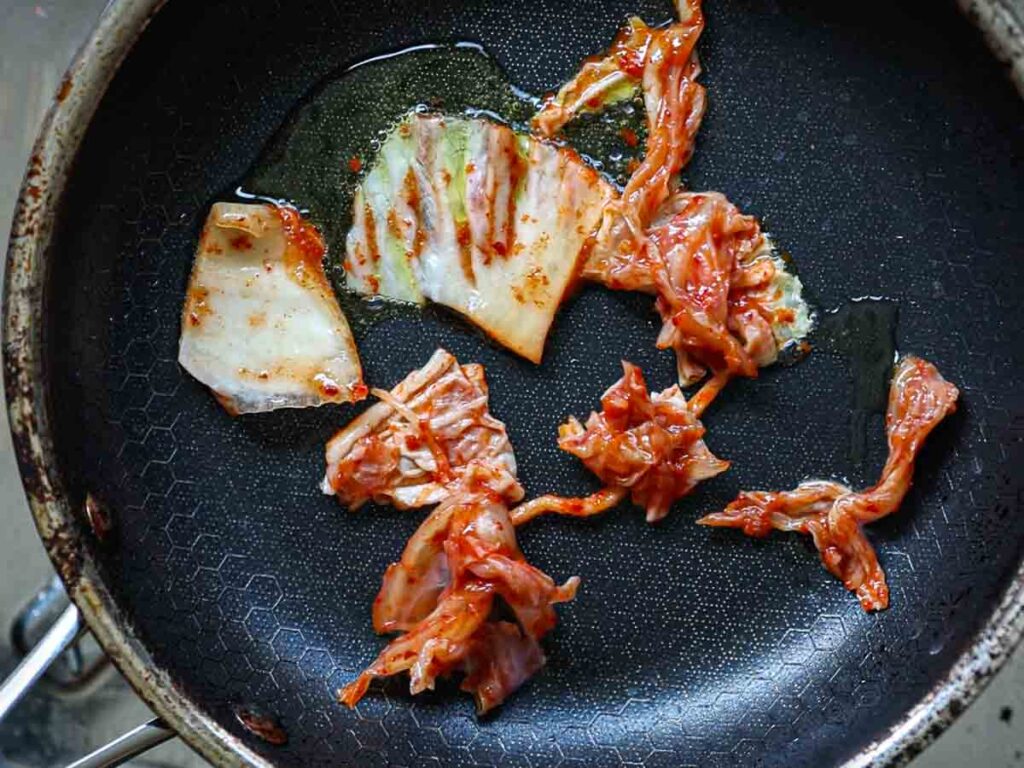 adding-kimchi-to-pan-before-adding-bindaetteok-batter