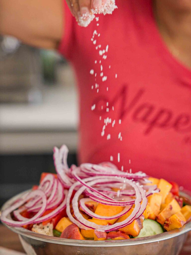 adding-salt-to-bread-salad