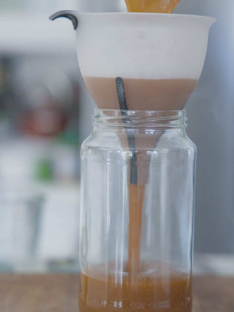 pouring-korean-bbq-sauce-into-jar-through-funnel