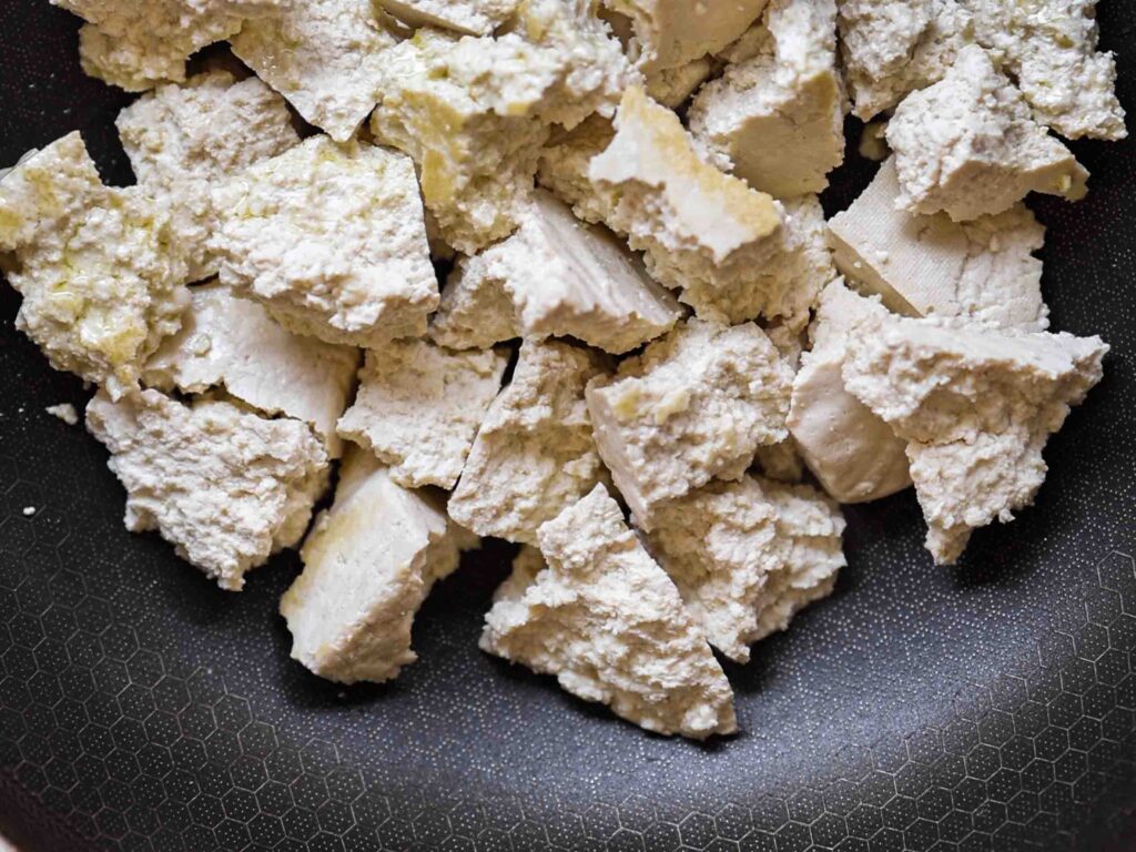 close up shot of browning tofu in pan