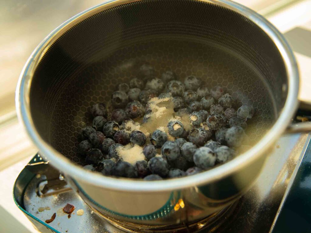 blueberries in saucepot with sugar