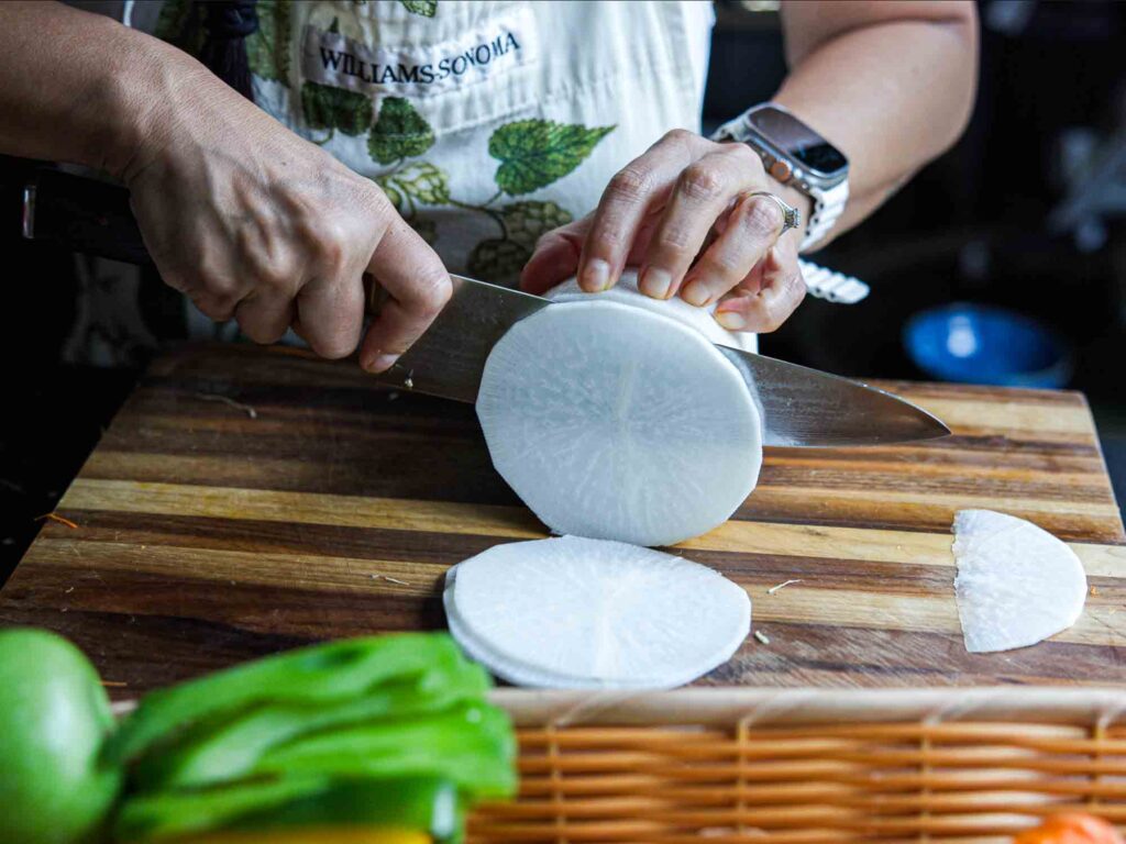 slicing korean radish into discs