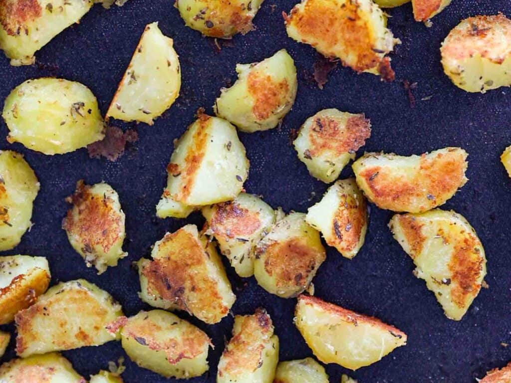 close up sheet pan of garlicky roasted potatoes