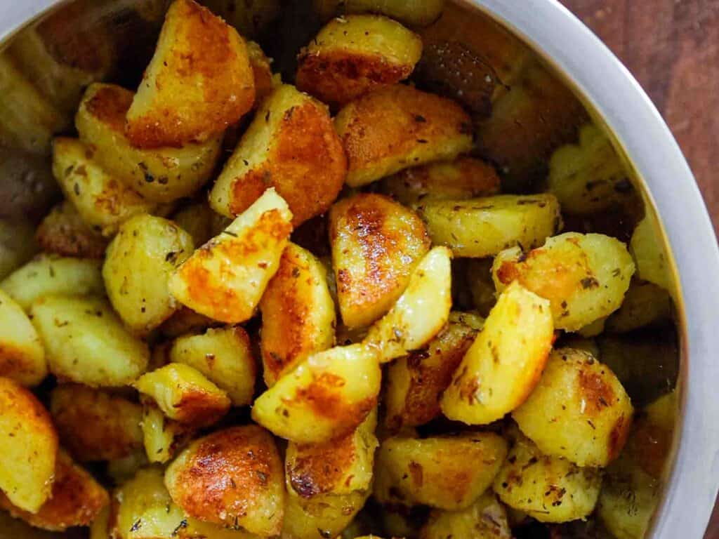 close up bowl of garlicky roasted potatoes