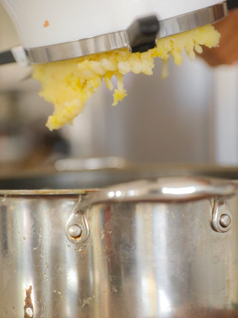 potatoes coming out of bottom of food mill