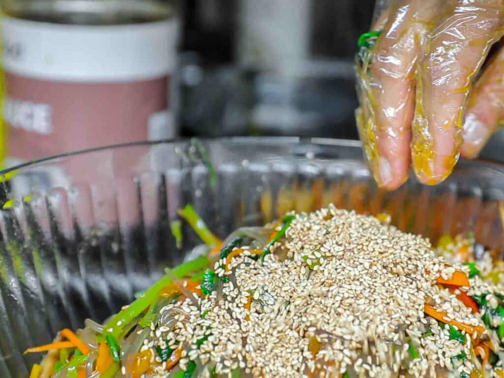 toasted sesame seeds added to vegetarian japchae