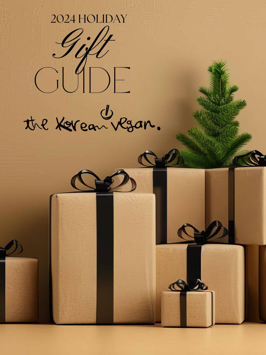 A stack of beige gift boxes with black ribbons sits beside a small green pine branch. Above, the text proudly reads "2024 Holiday Gift Guide" by The Korean Vegan. The warm tan background perfectly complements this festive scene, capturing the essence of thoughtful holiday giving.