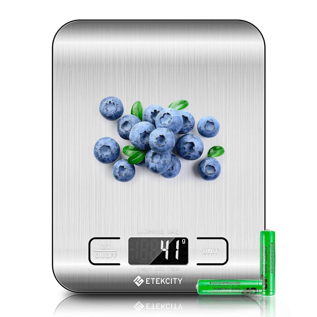 A digital kitchen scale, perhaps the perfect addition to a Korean Vegan's arsenal, displays 41 grams with a cluster of blueberries on its stainless steel surface. Two green AAA batteries sit beside it—a thoughtful choice for any Holiday Gift.