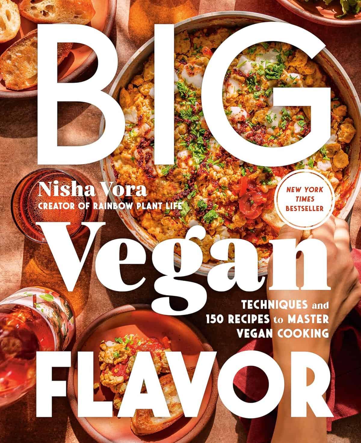 Cover of Big Vegan Flavor by Nisha Vora. Features a colorful vegan dish and text: Techniques and 150 Recipes to Master Vegan Cooking. Includes the label New York Times Bestseller, making it an ideal holiday gift, and showcases vibrant, inviting food photography.