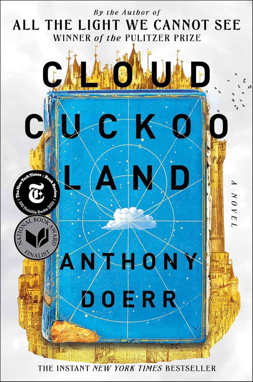 The cover of Cloud Cuckoo Land by Anthony Doerr, a perfect addition to the 2024 Holiday Gift Guide, features a blue book with celestial designs and gold architecture above it. The cover highlights the novel's awards and the author's previous works.