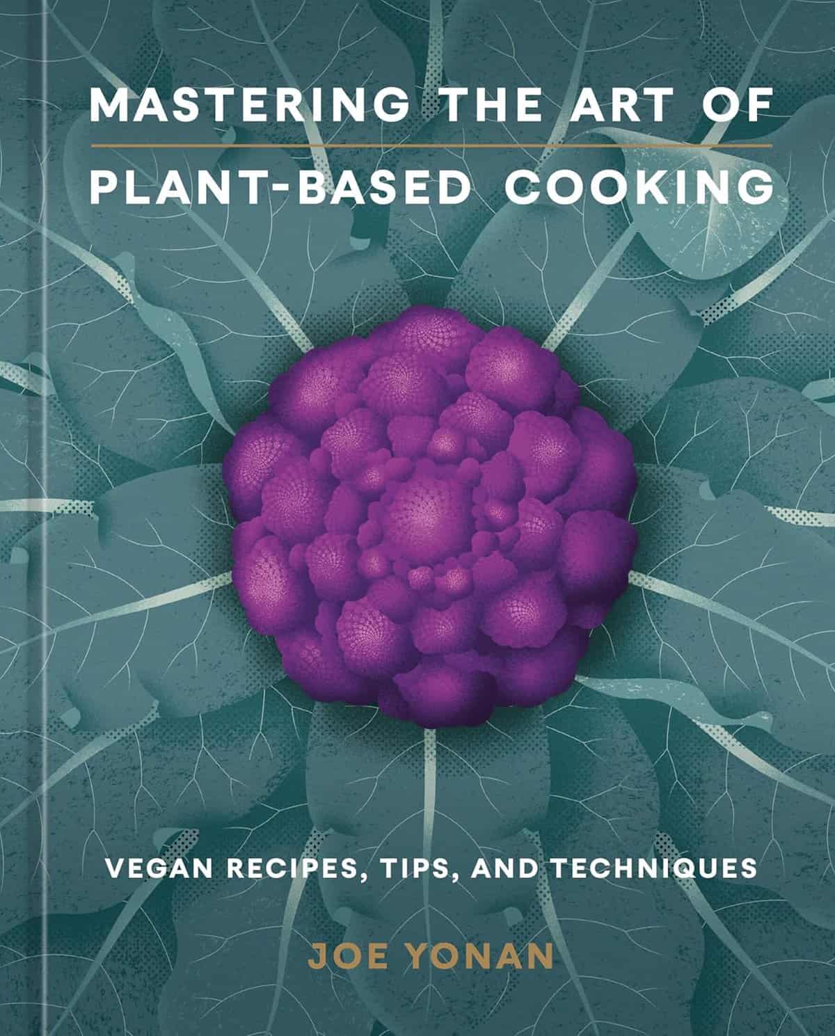 Cover of Mastering the Art of Plant-Based Cooking by Joe Yonan. Features a purple cauliflower with textured green leaves, accompanied by white text detailing the title and subtitle Vegan Recipes, Tips, and Techniques.