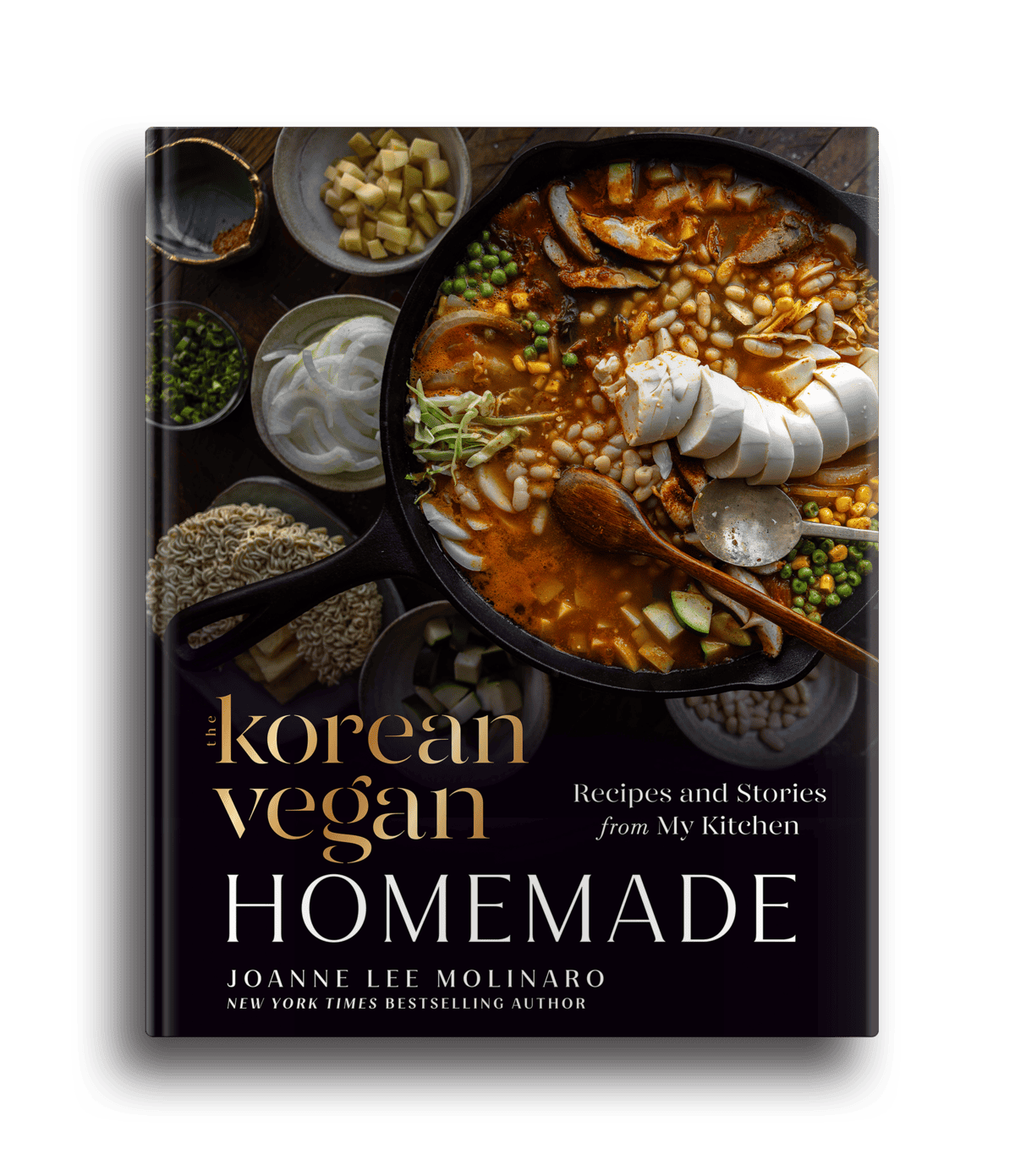 The cover of The Korean Vegan Cookbook by Joanne Lee Molinaro showcases a homemade bowl of stew with sliced tofu, mushrooms, green onions, and rice cakes. Surrounding the bowl are an array of ingredients like beans and spices. The text reads Recipes and Stories from My Kitchen.